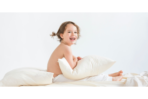 Toddler holding a Zizzz pillow