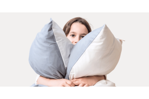 Child holding 2 Zizzz pillows 
