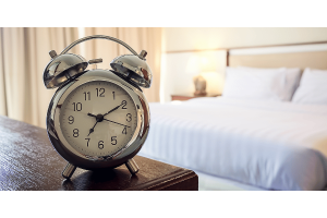 Alarm clock next to a bed
