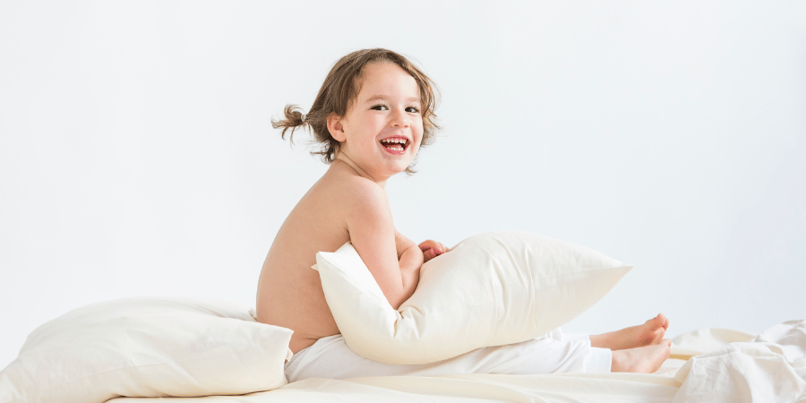 Toddler holding a Zizzz pillow