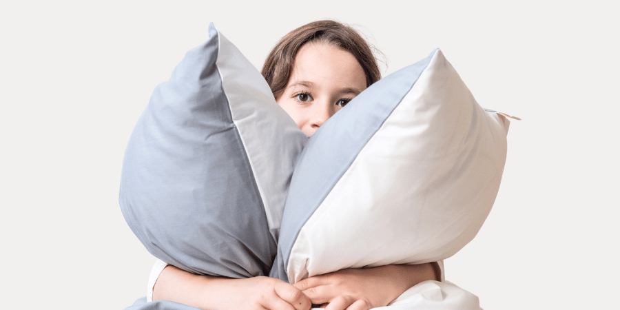Child holding 2 Zizzz pillows 