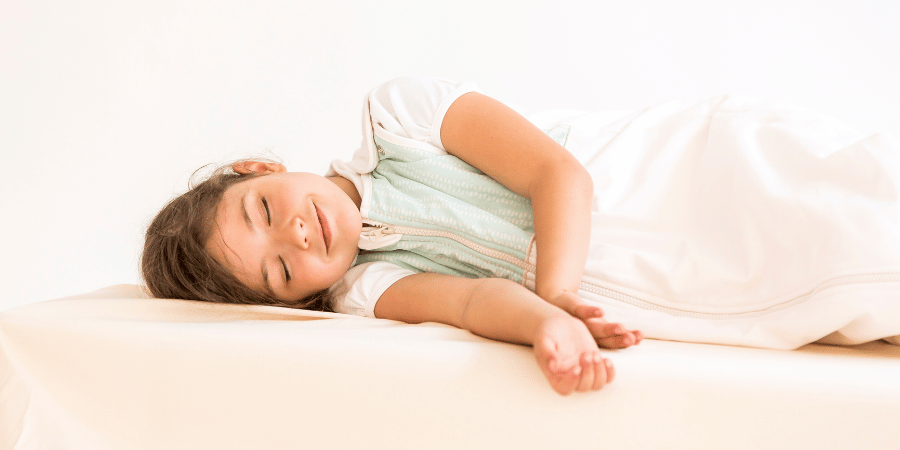 Little girl smiling while sleeping