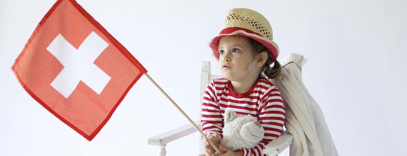 Child holding a Swiss flag