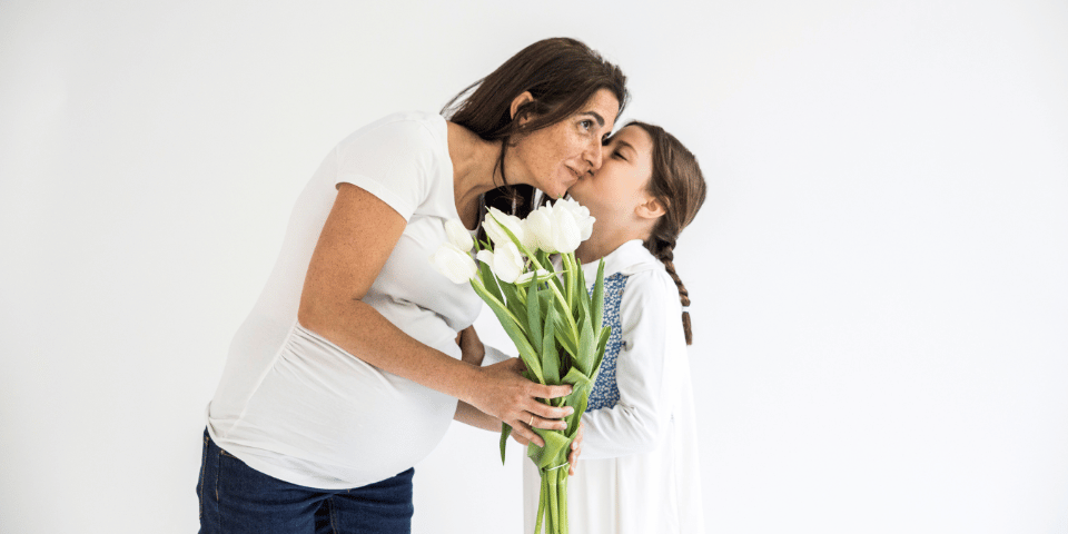 Femme enceinte recevant un bouquet de fleurs