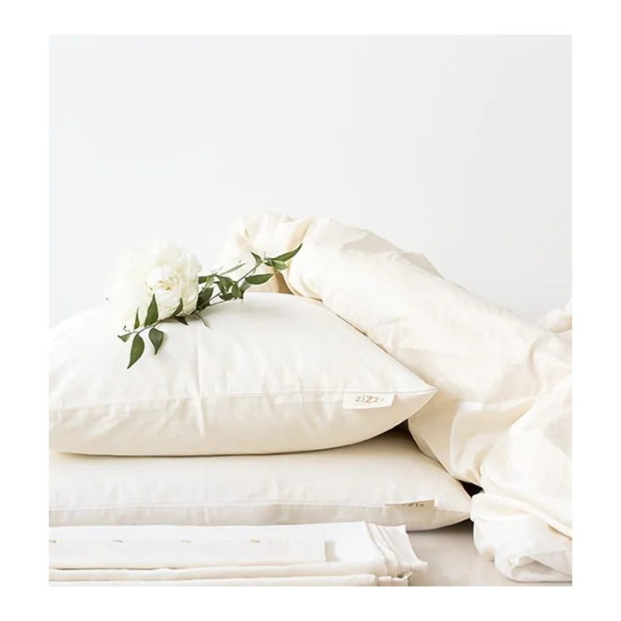 Parures de lit satin Zizzz surmontées d'une rose blanche